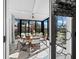 Bright sunroom with a glass-top table and seating for six at 4215 Gulf Of Mexico Dr # 103, Longboat Key, FL 34228