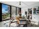 Sunroom features glass doors, round table and chairs, and ocean view at 4215 Gulf Of Mexico Dr # 103, Longboat Key, FL 34228