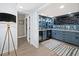 Basement wet bar with blue cabinetry, granite countertops, and wine storage at 4215 Gulf Of Mexico Dr # 103, Longboat Key, FL 34228