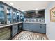Stylish wet bar featuring blue cabinets and granite countertops at 4215 Gulf Of Mexico Dr # 103, Longboat Key, FL 34228