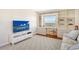 Den with a large TV, built-in desk and seating area at 435 S Gulfstream Ave # 1004, Sarasota, FL 34236