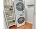 Laundry room with stackable washer and dryer and shelving at 435 S Gulfstream Ave # 1004, Sarasota, FL 34236