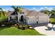 Tan two-story house with three-car garage and palm trees at 4610 Balboa Park Loop, Lakewood Ranch, FL 34211