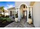 Elegant entryway with columns, arched entry, and large potted plants at 4610 Balboa Park Loop, Lakewood Ranch, FL 34211