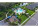Aerial view of community pool, playground, and surrounding landscape at 4755 Woodbrook Dr, Sarasota, FL 34243