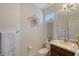 Clean bathroom with a single sink vanity, toilet, and decorative accents at 4755 Woodbrook Dr, Sarasota, FL 34243