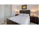 Bedroom with dark wood bed frame, light bedding, and hardwood floors at 4755 Woodbrook Dr, Sarasota, FL 34243