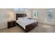 Bedroom with dark wood platform bed, light bedding, and private access door at 4755 Woodbrook Dr, Sarasota, FL 34243