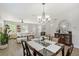 Bright dining room features a glass-top table with wood chairs, and hardwood floors at 4755 Woodbrook Dr, Sarasota, FL 34243
