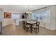 Dining room with hardwood floors and six-chair table at 4755 Woodbrook Dr, Sarasota, FL 34243