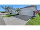 Two-car garage with driveway and landscaping at 4755 Woodbrook Dr, Sarasota, FL 34243