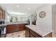 Open kitchen features an island, granite countertops, and dark wood cabinets at 4755 Woodbrook Dr, Sarasota, FL 34243