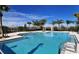 Inviting community swimming pool with palm trees and pergola at 4755 Woodbrook Dr, Sarasota, FL 34243