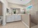 Spa-like bathroom with double vanity, a walk-in shower, and neutral tile at 4831 Boston Common Gln, Bradenton, FL 34211