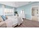 Charming bedroom with light blue walls, a comfortable bed, and ample natural light at 4831 Boston Common Gln, Bradenton, FL 34211