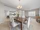 Open concept dining room with modern chandelier and kitchen view at 4831 Boston Common Gln, Bradenton, FL 34211