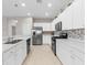 Modern kitchen with white cabinets and stainless steel appliances at 4831 Boston Common Gln, Bradenton, FL 34211
