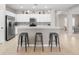 Kitchen island with three gray metal stools, stainless steel appliances at 4831 Boston Common Gln, Bradenton, FL 34211