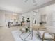 Open living room with comfy armchairs and a glass-top coffee table at 4831 Boston Common Gln, Bradenton, FL 34211