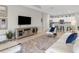 Bright living room with open floor plan, modern furniture, and a view of the kitchen at 4831 Boston Common Gln, Bradenton, FL 34211