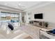 Bright living room with white couches and large TV at 4831 Boston Common Gln, Bradenton, FL 34211