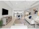 Open concept living room featuring a white sofa, tile floors, and a view of the kitchen at 4831 Boston Common Gln, Bradenton, FL 34211