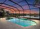 Enclosed pool and spa area with lake views at sunset at 4831 Boston Common Gln, Bradenton, FL 34211