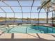 Relaxing screened pool area overlooking a serene lake at 4831 Boston Common Gln, Bradenton, FL 34211