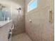 Walk-in shower with grab bars and tiled walls at 4831 Boston Common Gln, Bradenton, FL 34211
