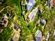 Aerial view of waterfront homes with lush landscaping and private pools at 4839 Primrose Path, Sarasota, FL 34242