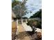 Landscaped side yard with a walkway leading to the water at 4839 Primrose Path, Sarasota, FL 34242