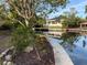 Peaceful waterfront view of a canal with tree reflections at 4839 Primrose Path, Sarasota, FL 34242