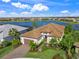 Single-story home with lake views, tile roof and lush landscaping at 4842 Pastel Ct, Sarasota, FL 34240