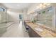 Double vanity bathroom with granite countertops and a soaking tub at 4842 Pastel Ct, Sarasota, FL 34240