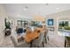 Open concept dining area with wood table and marble floors at 4842 Pastel Ct, Sarasota, FL 34240