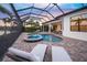 Resort-style pool and spa with covered patio at 4842 Pastel Ct, Sarasota, FL 34240