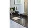Elegant bathroom with dark granite countertop and modern sink at 540 N Tamiami Trl # 702, Sarasota, FL 34236