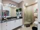 Bathroom with modern vanity, glass shower, and dark granite at 540 N Tamiami Trl # 702, Sarasota, FL 34236