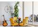 Small breakfast nook with yellow chairs and glass table at 540 N Tamiami Trl # 702, Sarasota, FL 34236