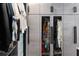 Walk-in closet with glass-front cabinets and custom organizers at 540 N Tamiami Trl # 702, Sarasota, FL 34236