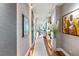 Bright hallway with hardwood floors and artwork at 540 N Tamiami Trl # 702, Sarasota, FL 34236