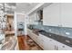 Modern kitchen with white cabinets, granite countertops, and a gas range at 540 N Tamiami Trl # 702, Sarasota, FL 34236