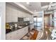 Modern kitchen with white cabinets, granite countertops, and stainless steel appliances at 540 N Tamiami Trl # 702, Sarasota, FL 34236