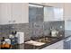 Modern kitchen sink with a gooseneck faucet and granite countertop at 540 N Tamiami Trl # 702, Sarasota, FL 34236