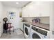 Bright laundry room with washer, dryer, and ample storage at 540 N Tamiami Trl # 702, Sarasota, FL 34236
