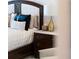 Detailed view of a bedroom nightstand with lamp and pillows at 540 N Tamiami Trl # 702, Sarasota, FL 34236