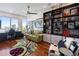 Home office with built-in shelving, hardwood floors, and a comfortable couch at 540 N Tamiami Trl # 702, Sarasota, FL 34236