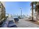 Relaxing pool and patio area with lounge seating and palm trees at 540 N Tamiami Trl # 702, Sarasota, FL 34236