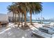 Relaxing rooftop pool and patio area with lounge chairs and palm trees at 540 N Tamiami Trl # 702, Sarasota, FL 34236