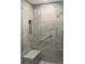 Walk-in shower with glass enclosure, built-in seat, and grab bar at 540 N Tamiami Trl # 702, Sarasota, FL 34236